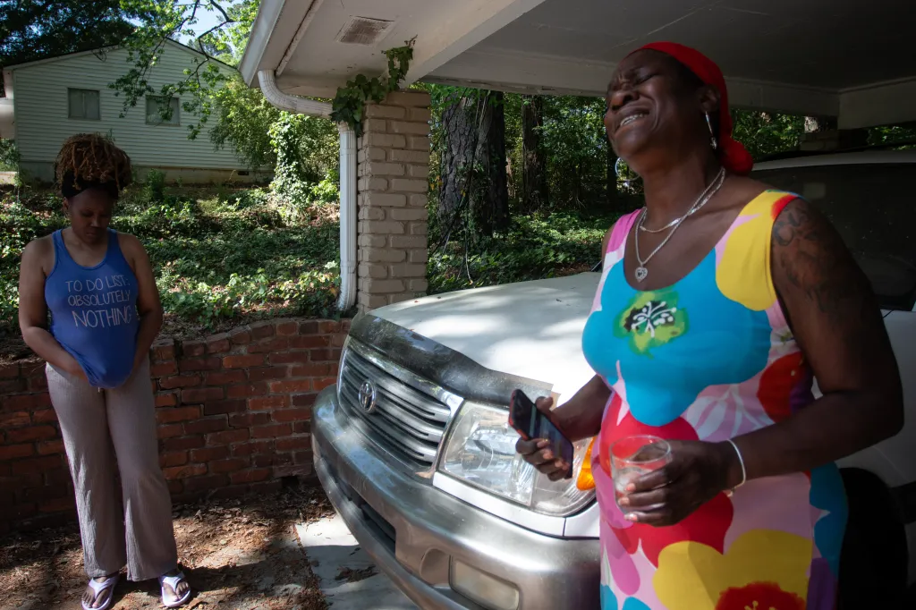 Angela Britton talking in her driveway.