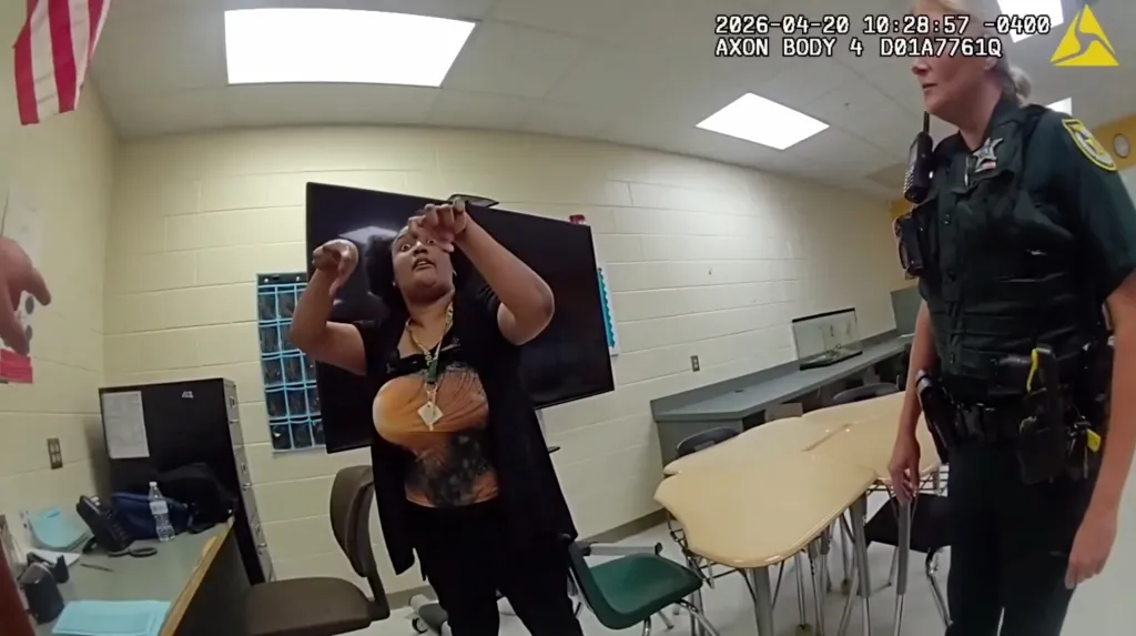 Angela Jourdan, a substitute teacher, being arrested by police in a classroom.