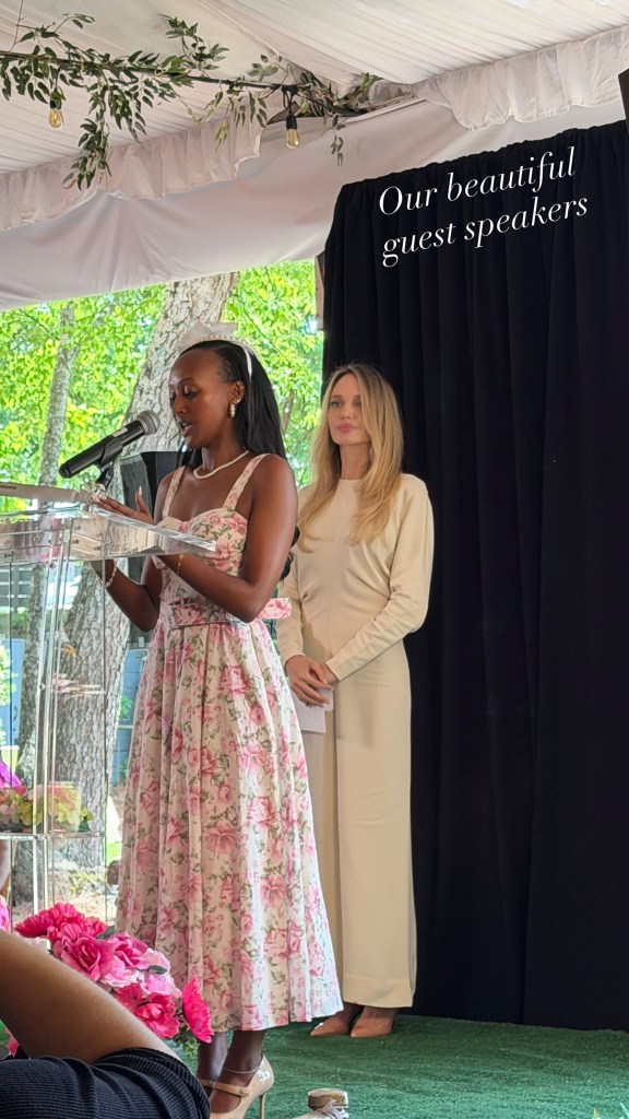 Zahara Jolie-Pitt speaking at a podium while Angelina Jolie stands beside her.