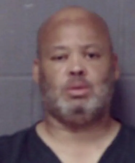 Mugshot of Tracey Matthews, a bald man with a graying beard.