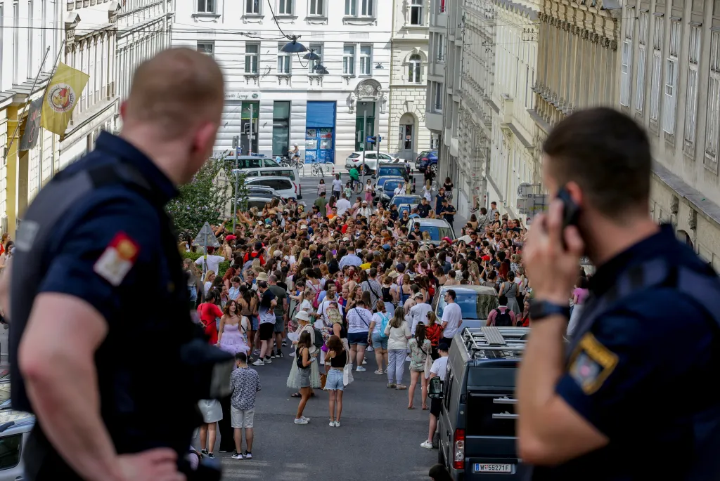 Austrian police officers watch a gathering of Taylor Swift fans in the city centre in Vienna on Aug. 8, 2024.