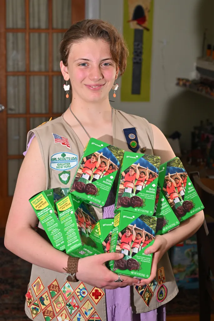 Ashleigh holds several boxes of Thin Mints.