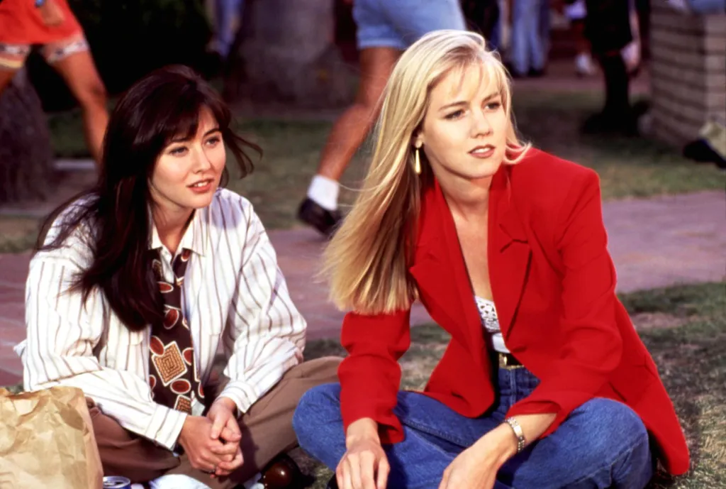 Shannen Doherty and Jennie Garth from Beverly Hills, 90210, wearing 1990s fashion.