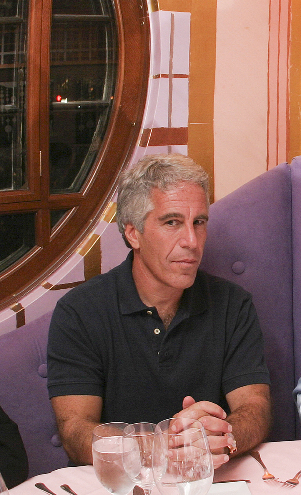 Jeffrey Epstein seated at a table.