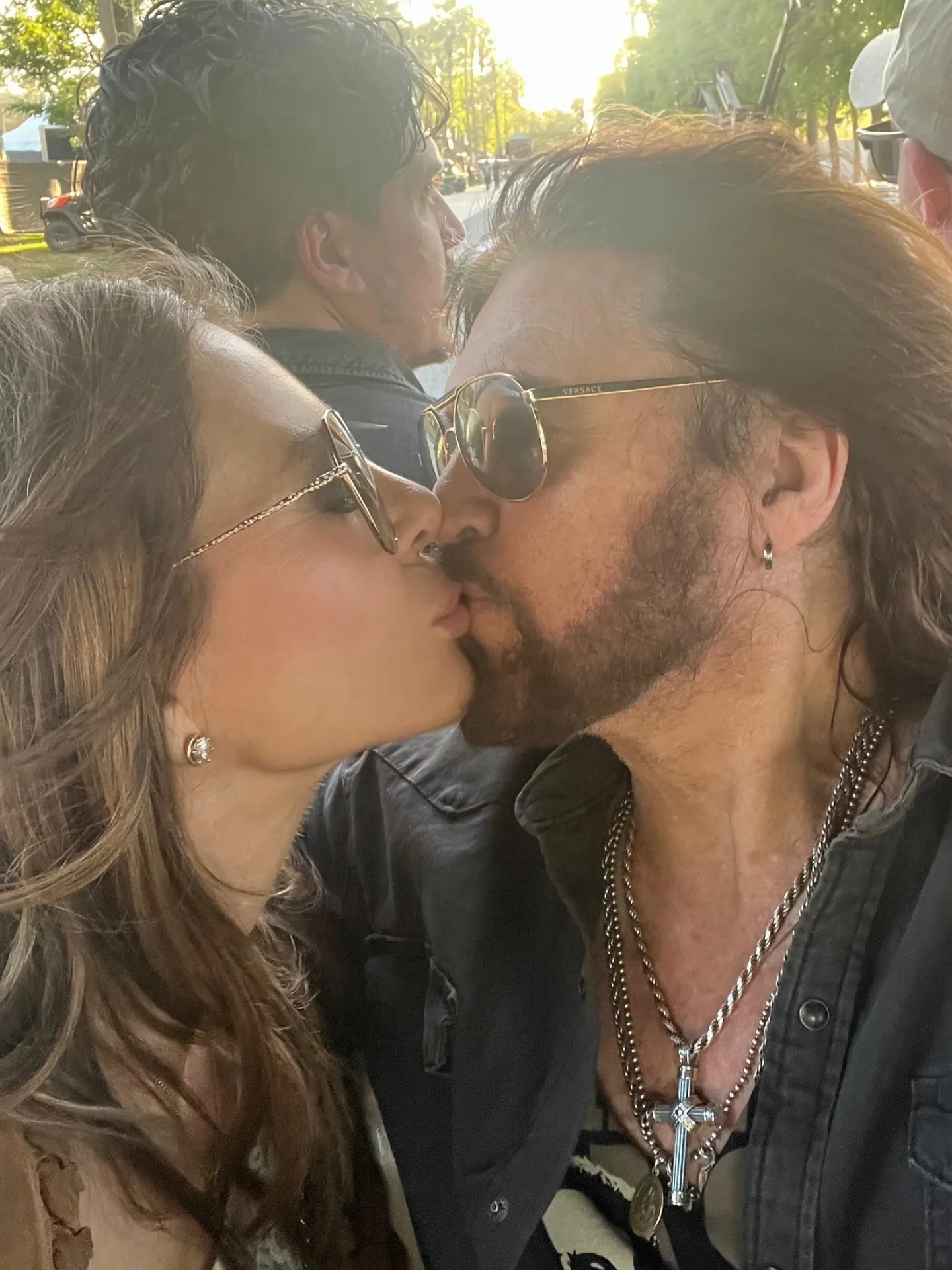 Elizabeth Hurley and Billy Ray Cyrus share a kiss.