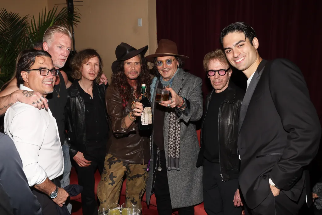 Bobby DeLeon, Josh Homme, Beck, Steven Tyler, Johnny Depp, Jerry Bruckheimer, and Matteo Bocelli posing at The Gathering of Three Hearts event.