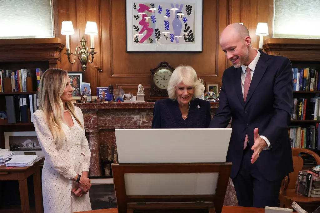 Queen Camilla, in a navy blue dress, Sarah Jessica Parker, in a cream dress.