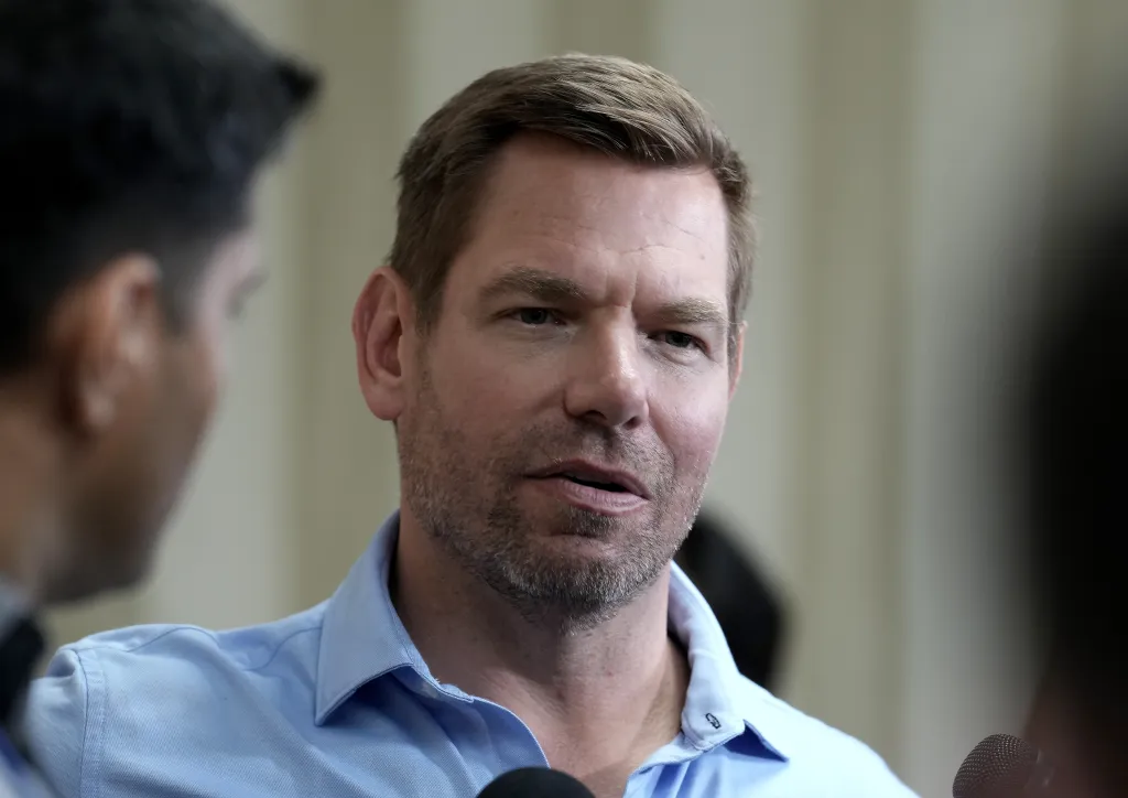 Rep. Eric Swalwell speaks to reporters after a town hall meeting.