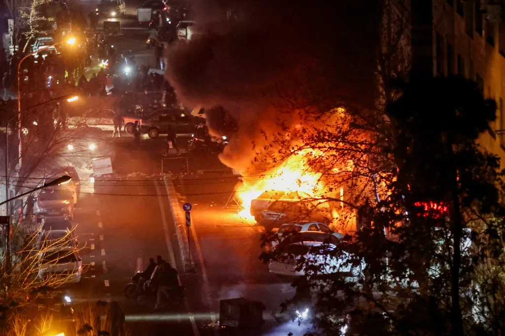 Cars burn in a street during a protest over the collapse of the currency's value, in Tehran, Iran.