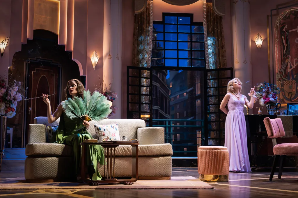 Two women on stage performing in 