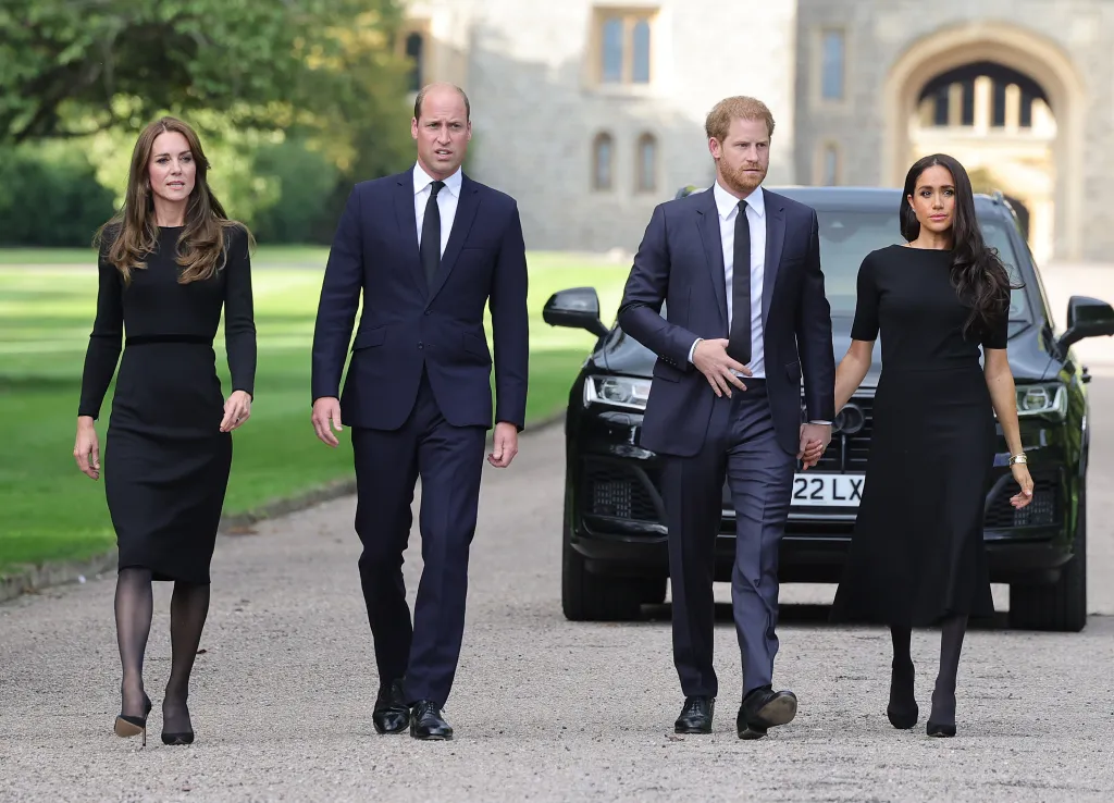 Catherine, Prince William, Prince Harry, and Meghan walk on the long Walk at Windsor Castle.