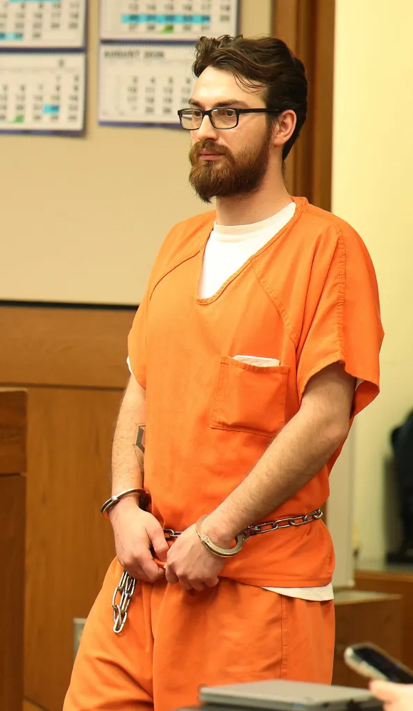 Chamel Abdulkarim in court, wearing an orange jumpsuit and handcuffs.