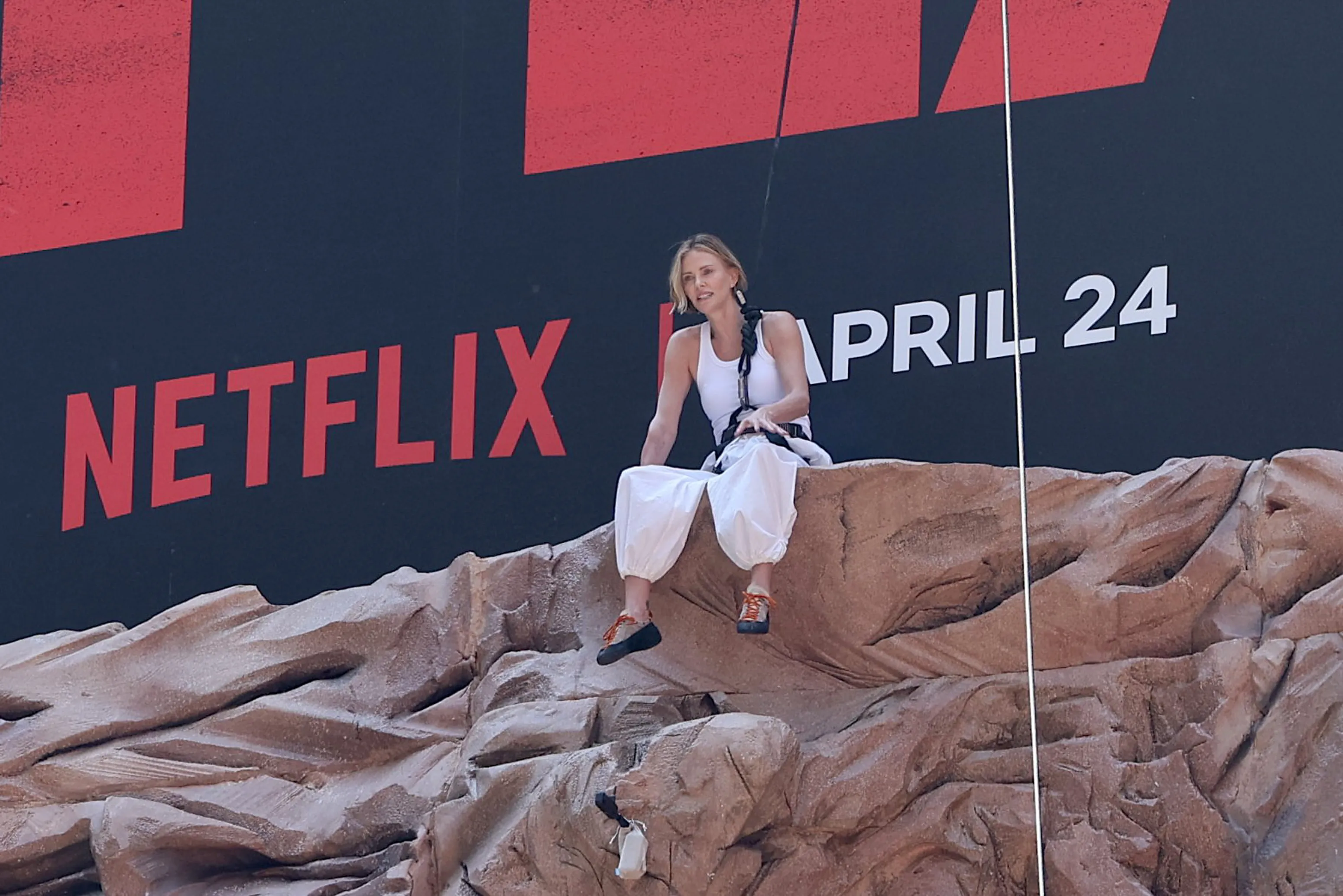 Charlize Theron is seen after climbing a wall to promote her new Netflix movie 