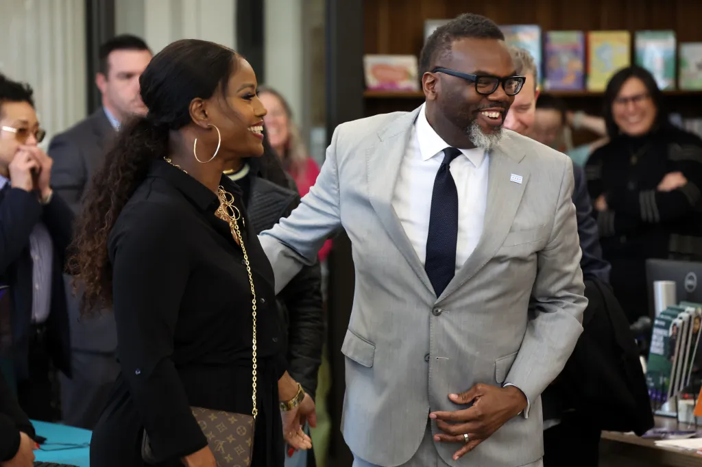 Chicago Teachers Union president Stacy Davis Gates, left, stands with Mayor Brandon Johnson as he arrives at the Legler Regional Branch of the Chicago Public Library on Feb. 7, 2024. 