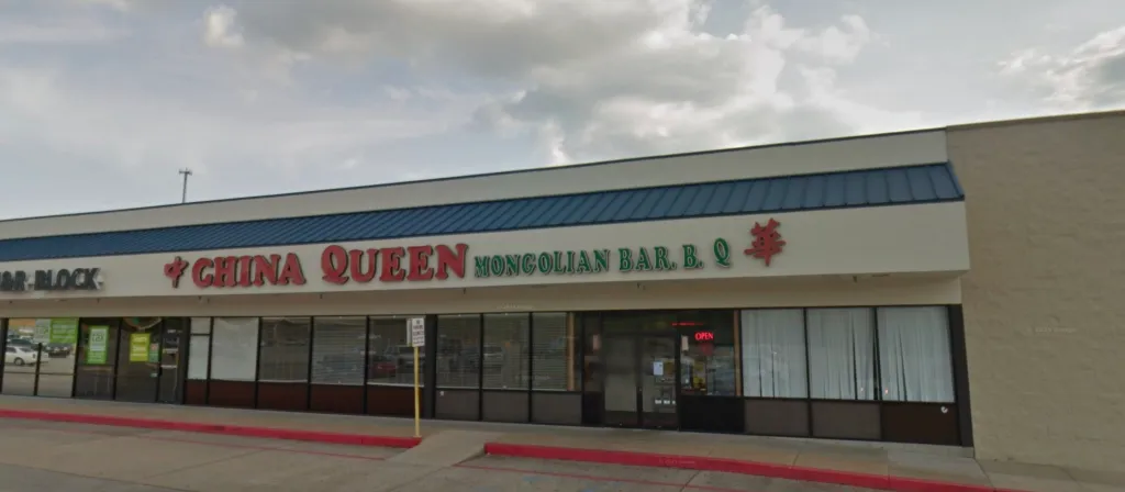 The storefront of the China Queen Mongolian Bar. B. Q. restaurant, with a red 