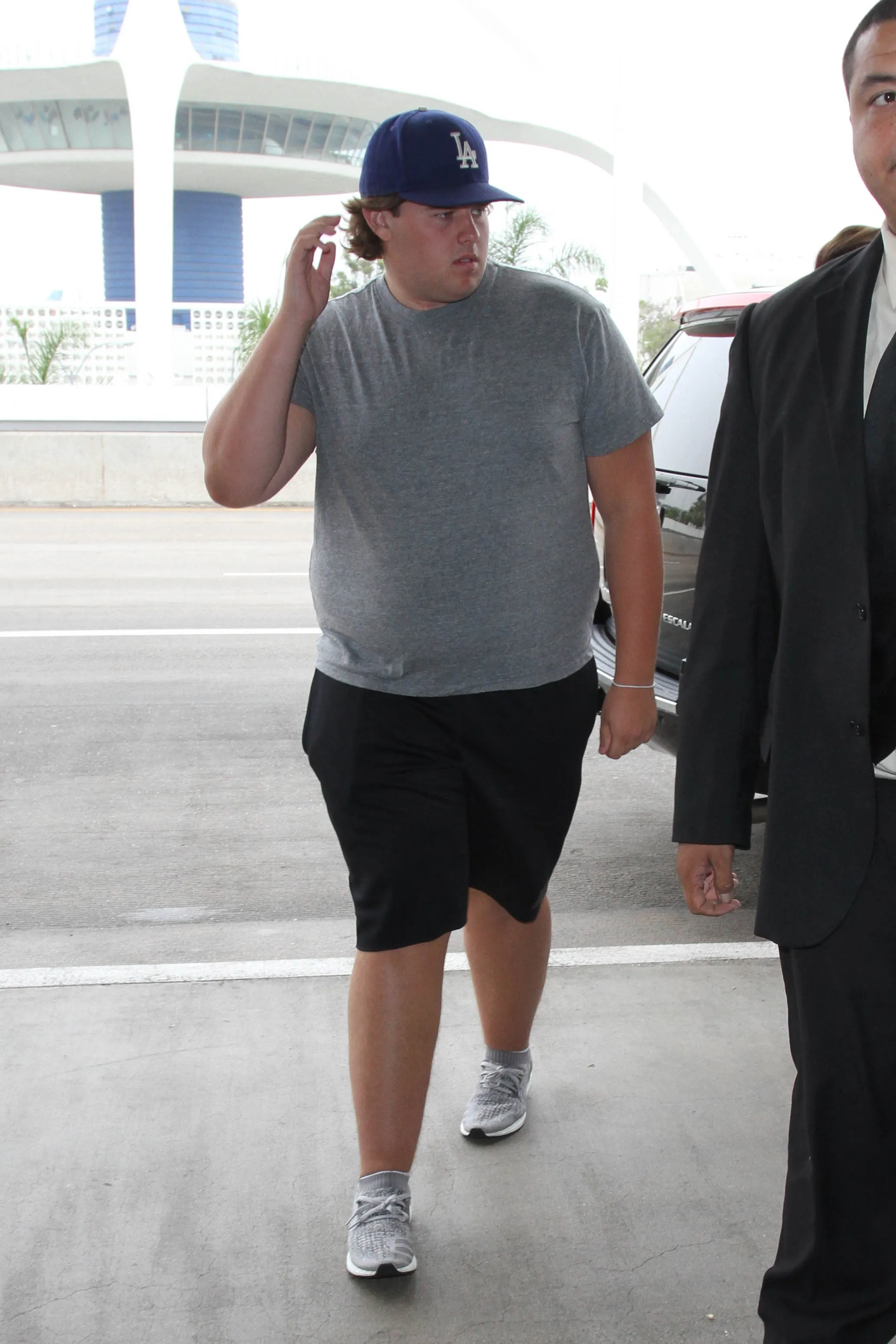 Christopher Schwarzenegger walking in casual clothes at LAX.