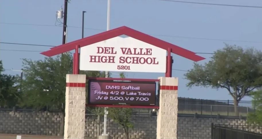 Del Valle High School sign with an electronic message board displaying 