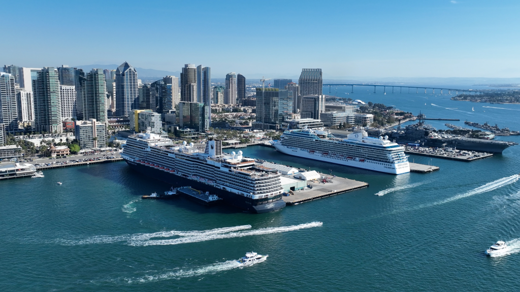 Aerial view of the San Diego skyline with cruise ships docked in the harbor.
