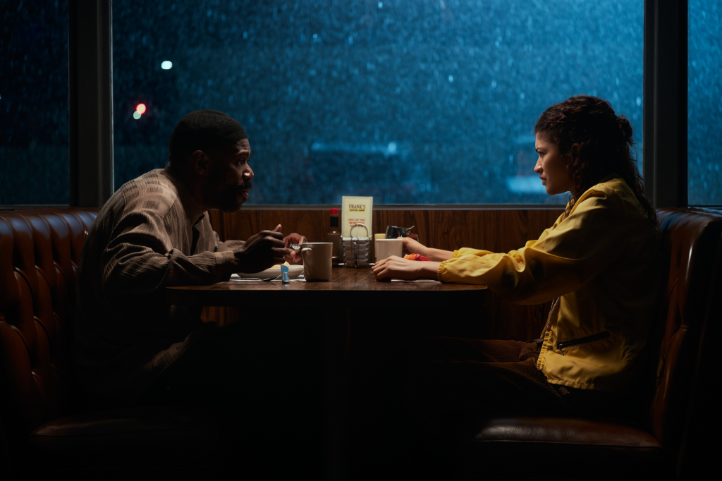 Colman Domingo and Zendaya sitting opposite each other at a diner booth.