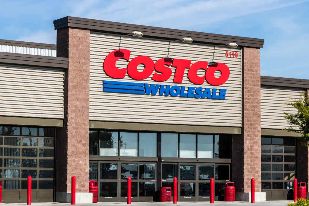 The exterior of a Costco Wholesale store, showing the large red and blue logo above the main entrance.