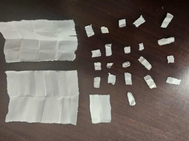 Pieces of white paper containing drugs confiscated from a prison.