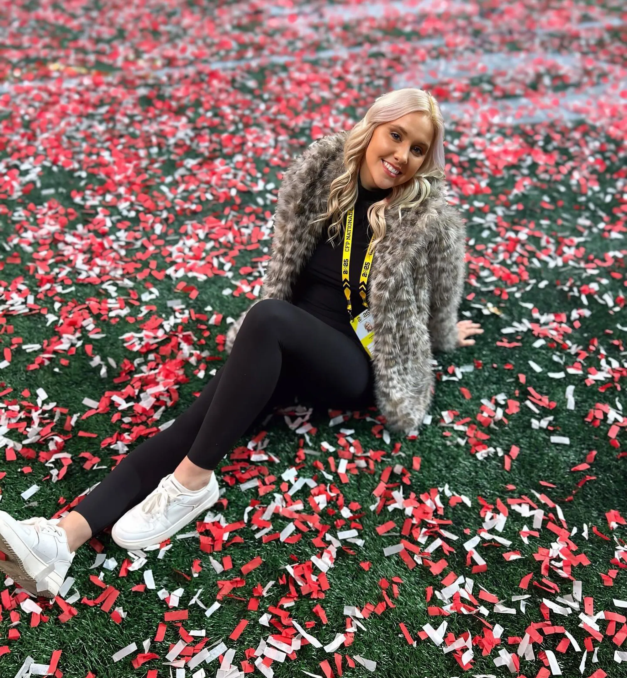 Crissy Froyd sitting on a field of red and white confetti.