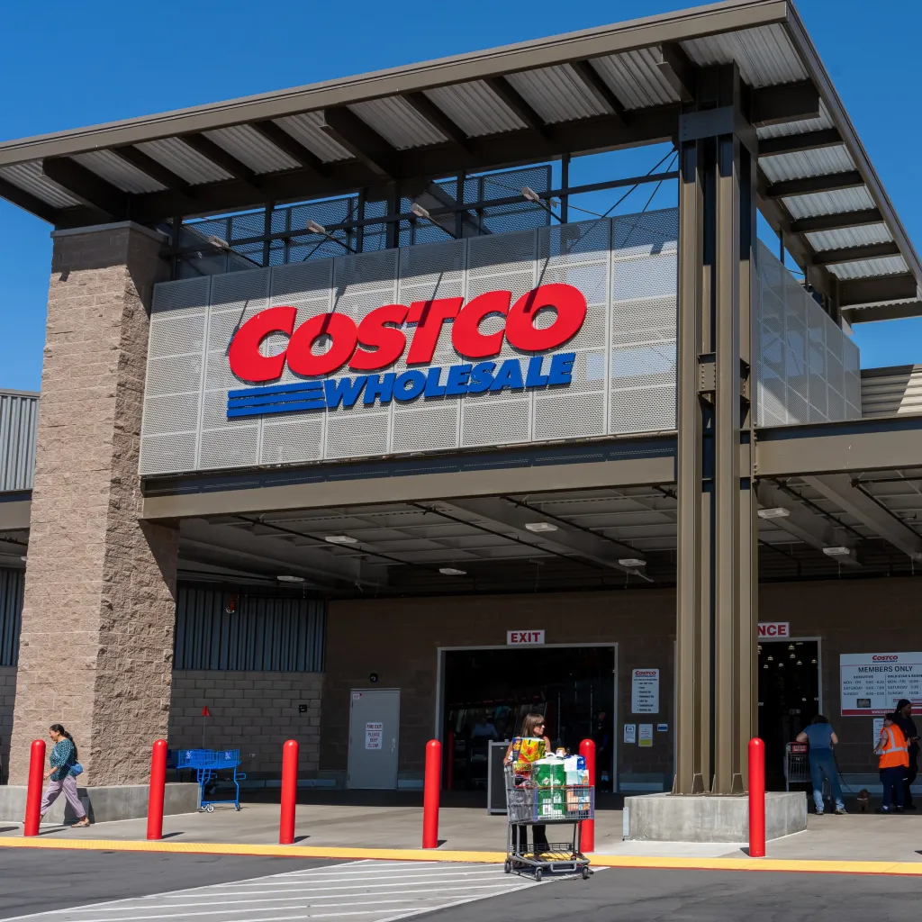 A Costco Wholesale store with customers entering and exiting the building.