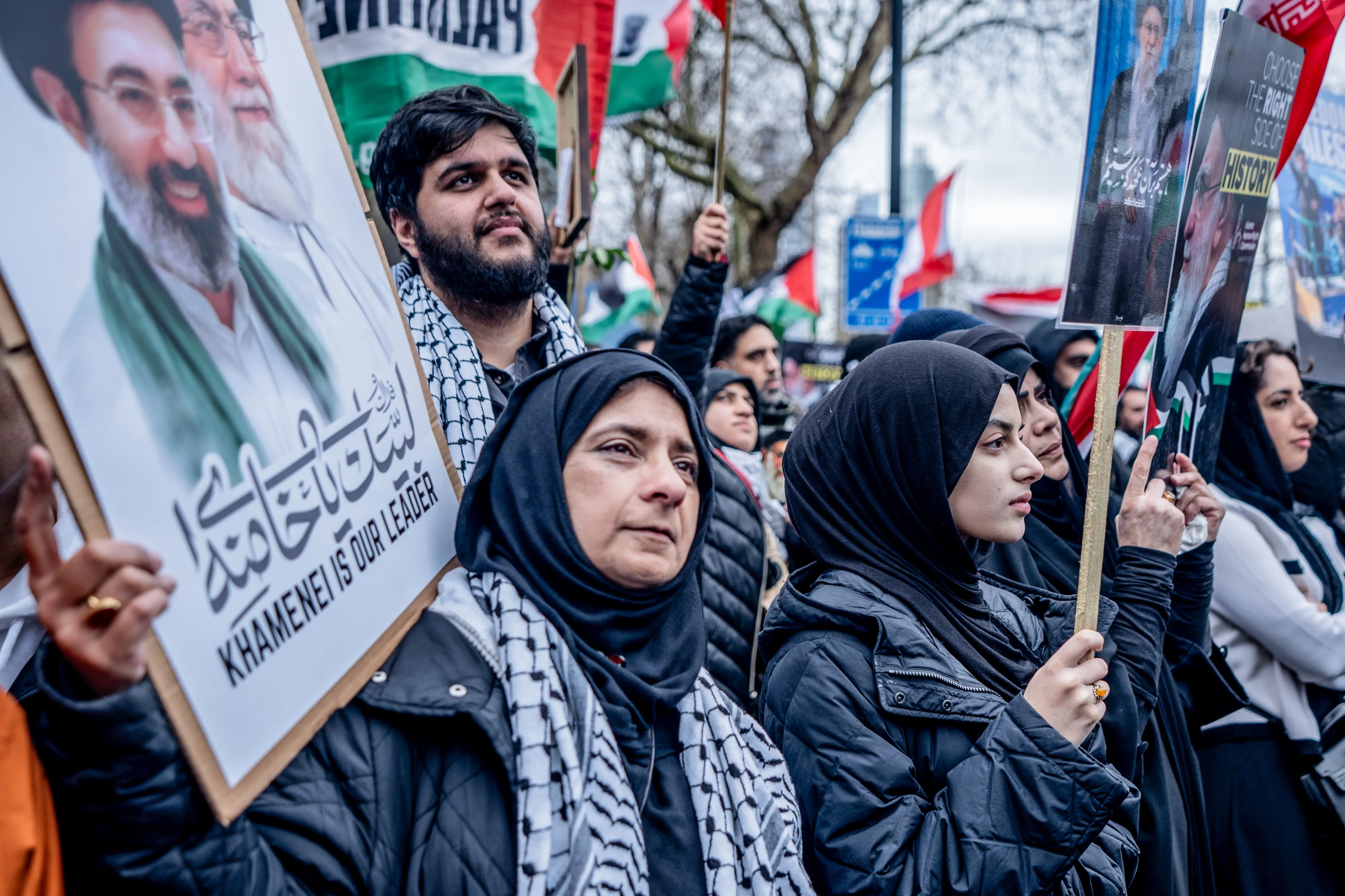Pro-Iranian regime British-Iranians at a rally in London holding posters of Ayatollah Ali Khamenei.