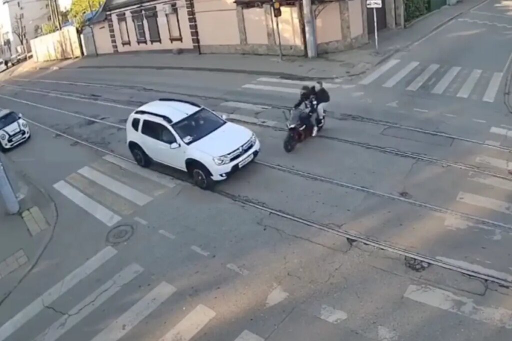Horrific moment motorcycle smashes into car, killing rider and seriously wounding passenger