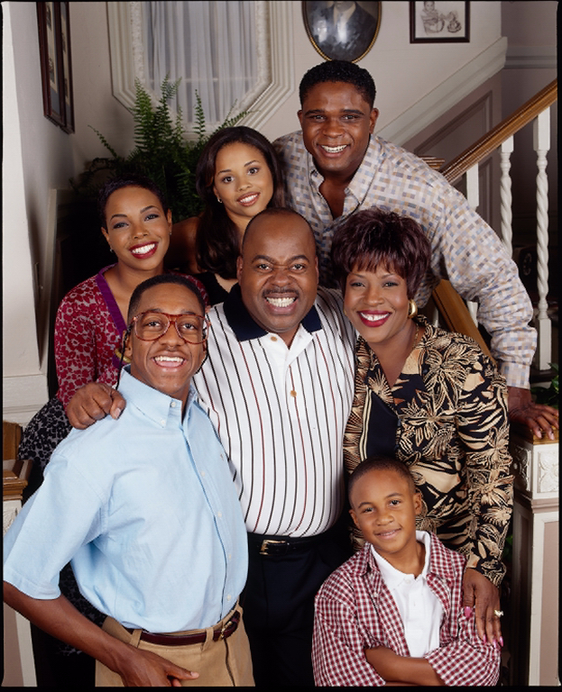 The cast of the TV show Family Matters posing on a staircase.