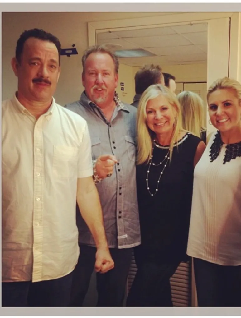 Tom Hanks, Darrell Sheets, and two women standing together indoors.
