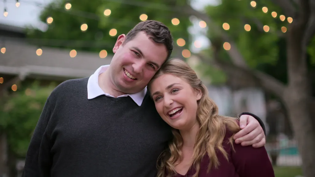 David and Abbey from Love on the Spectrum smiling with David's arm around Abbey.