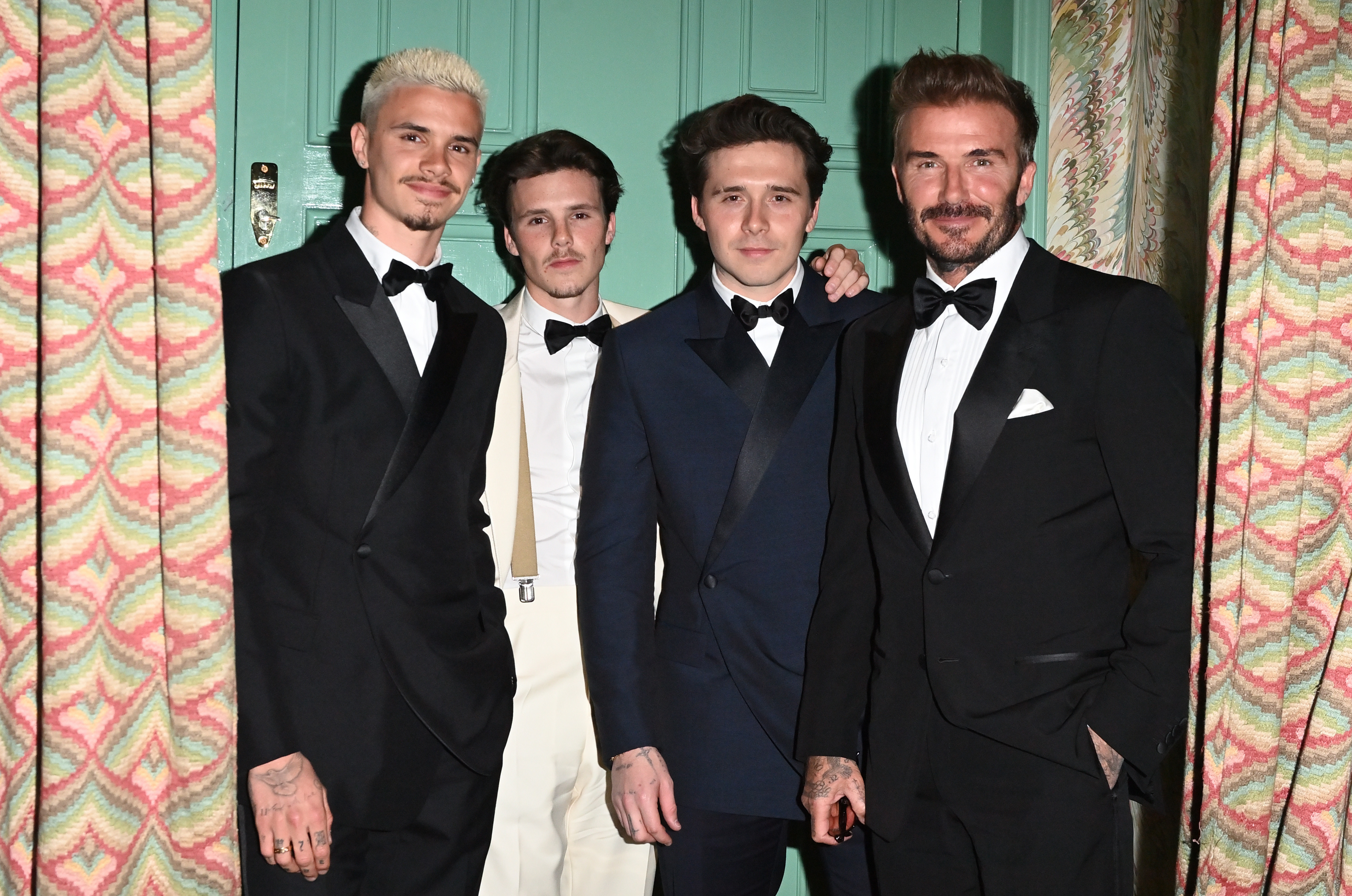 David Beckham, Brooklyn Beckham, Romeo Beckham, and Cruz Beckham posing at Victoria Beckham's 50th Birthday Party.
