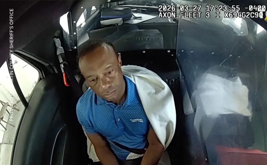 Tiger Woods shown dazed in the back of a police car.