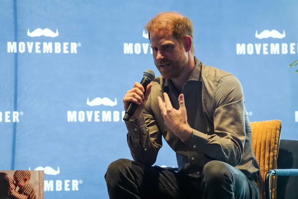 Prince Harry speaking into a microphone during a Movember Q&A session.