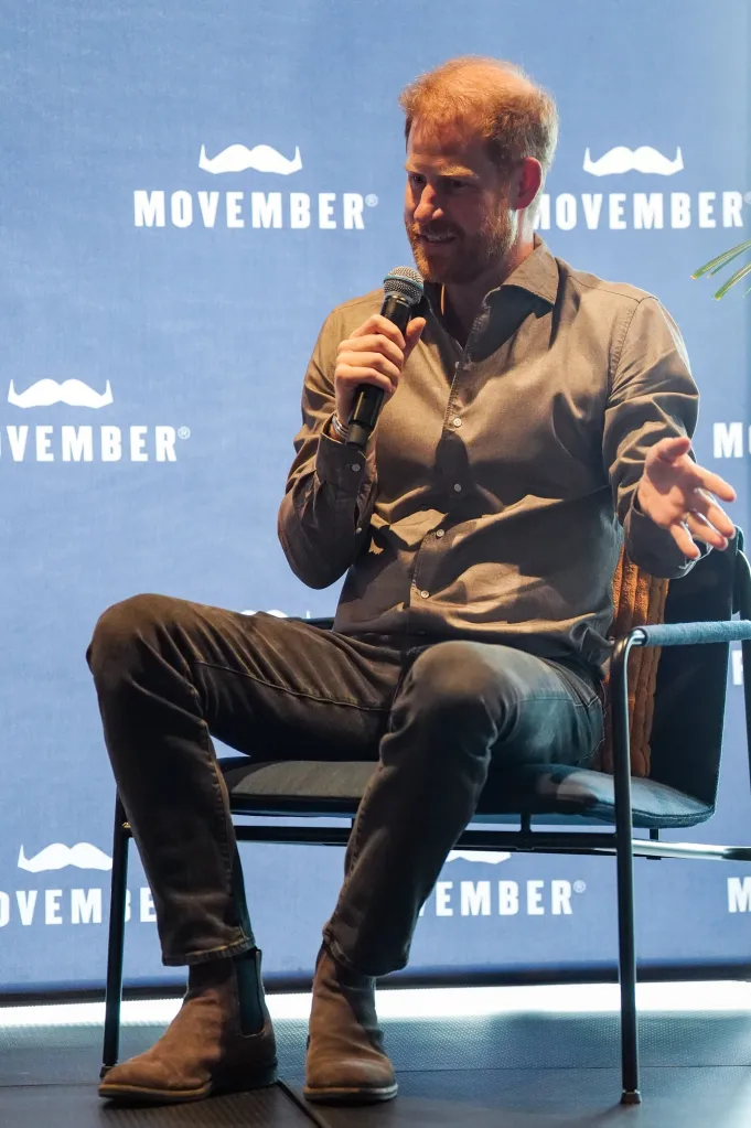Prince Harry speaking into a microphone during a Movember event.