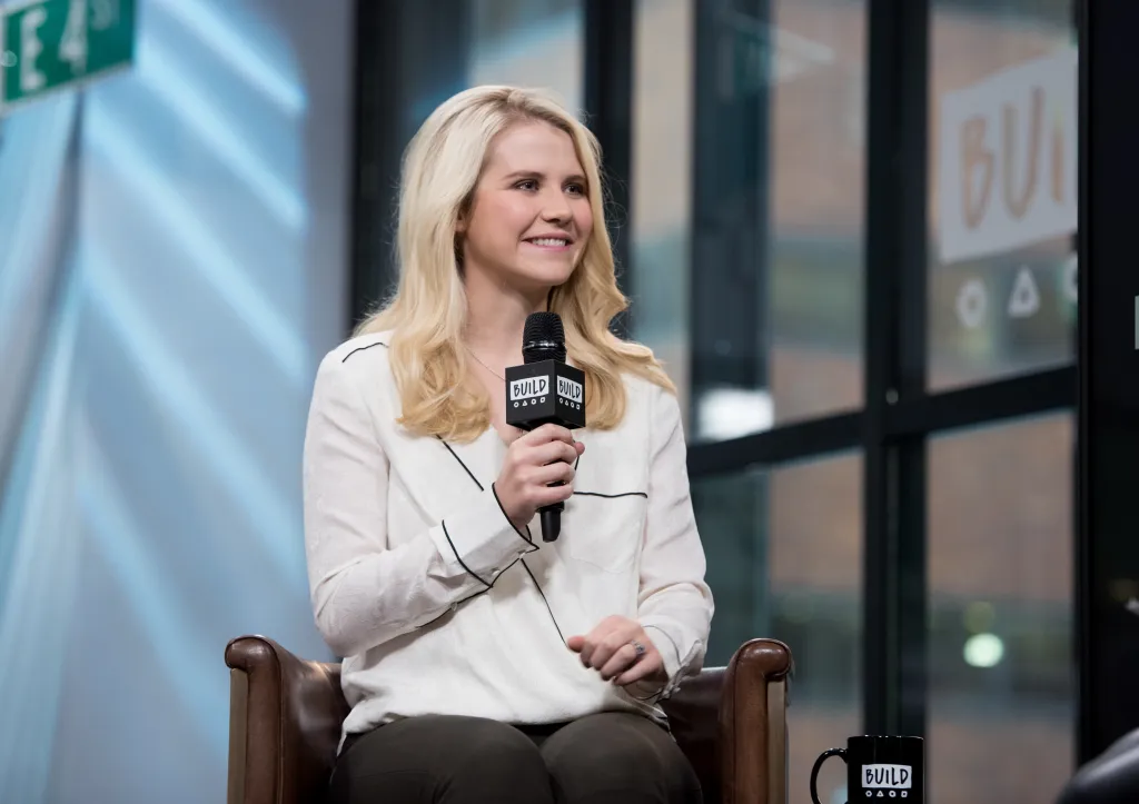 Elizabeth Smart holds a microphone, speaking at Build Studio.