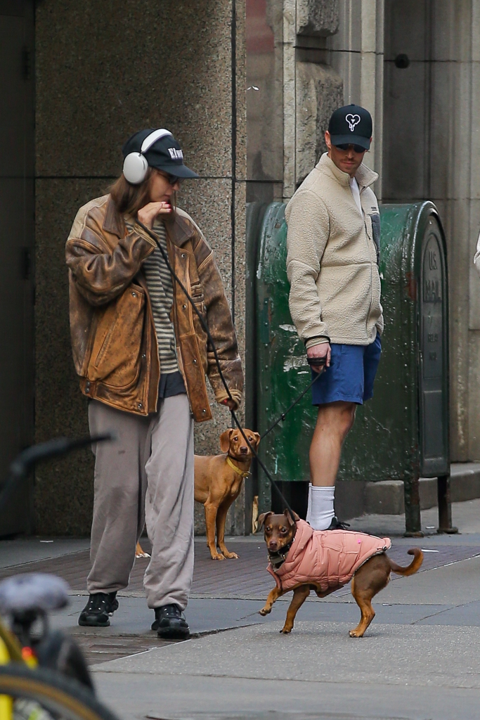 Amanda Batula and Kyle Cooke walking dogs in New York City.