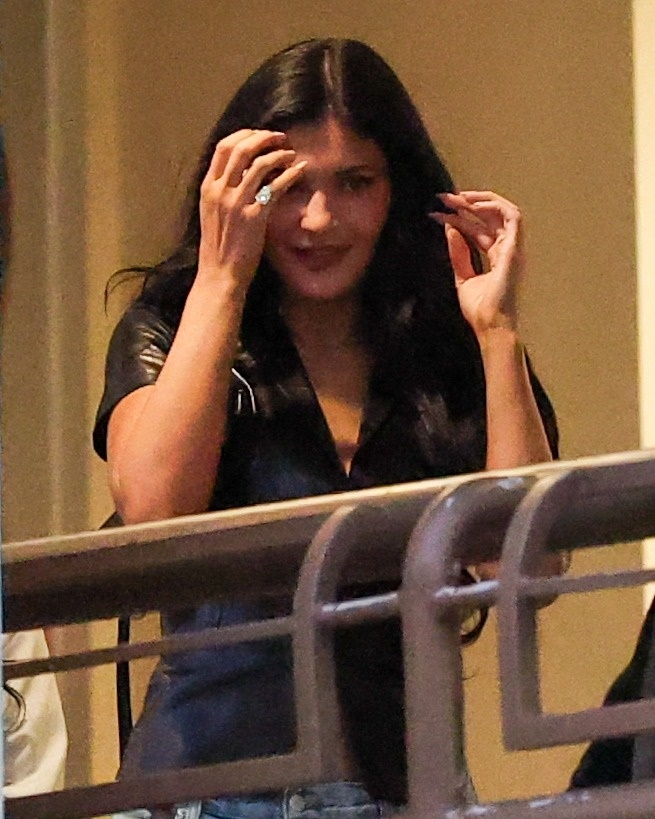 Kylie Jenner showing off a large diamond ring on her left hand.