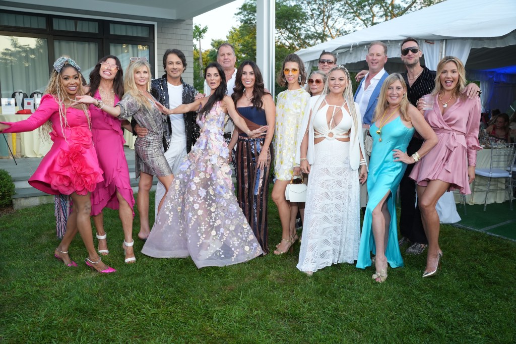 A group of people dressed in formal attire posing for a photo at the Diabetes Research Institute Foundation Hamptons Garden Gala.