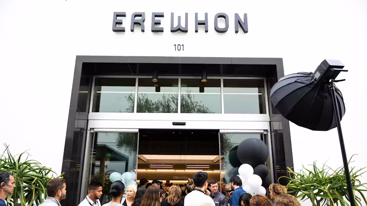 Shoppers enter and exit the crowded high-end grocery store Erewhon in Pasadena, Calif.