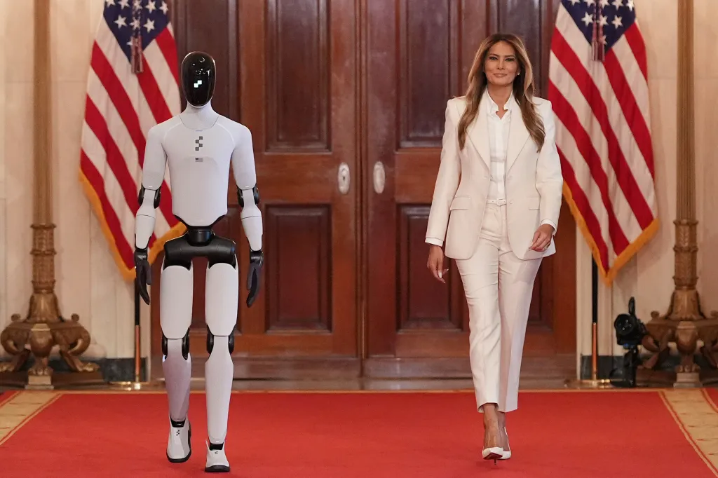 First lady Melania Trump walks alongside a robot during an event at the White House on March 25, 2026.