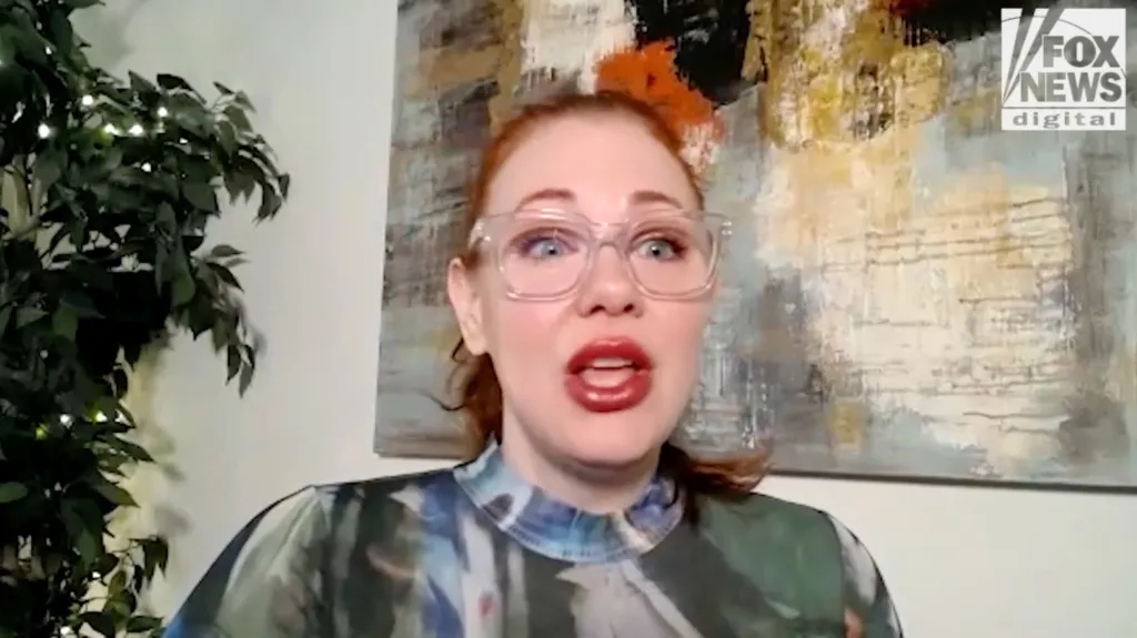 Maitland Ward in a video interview with Fox News, wearing glasses and a colorful top.