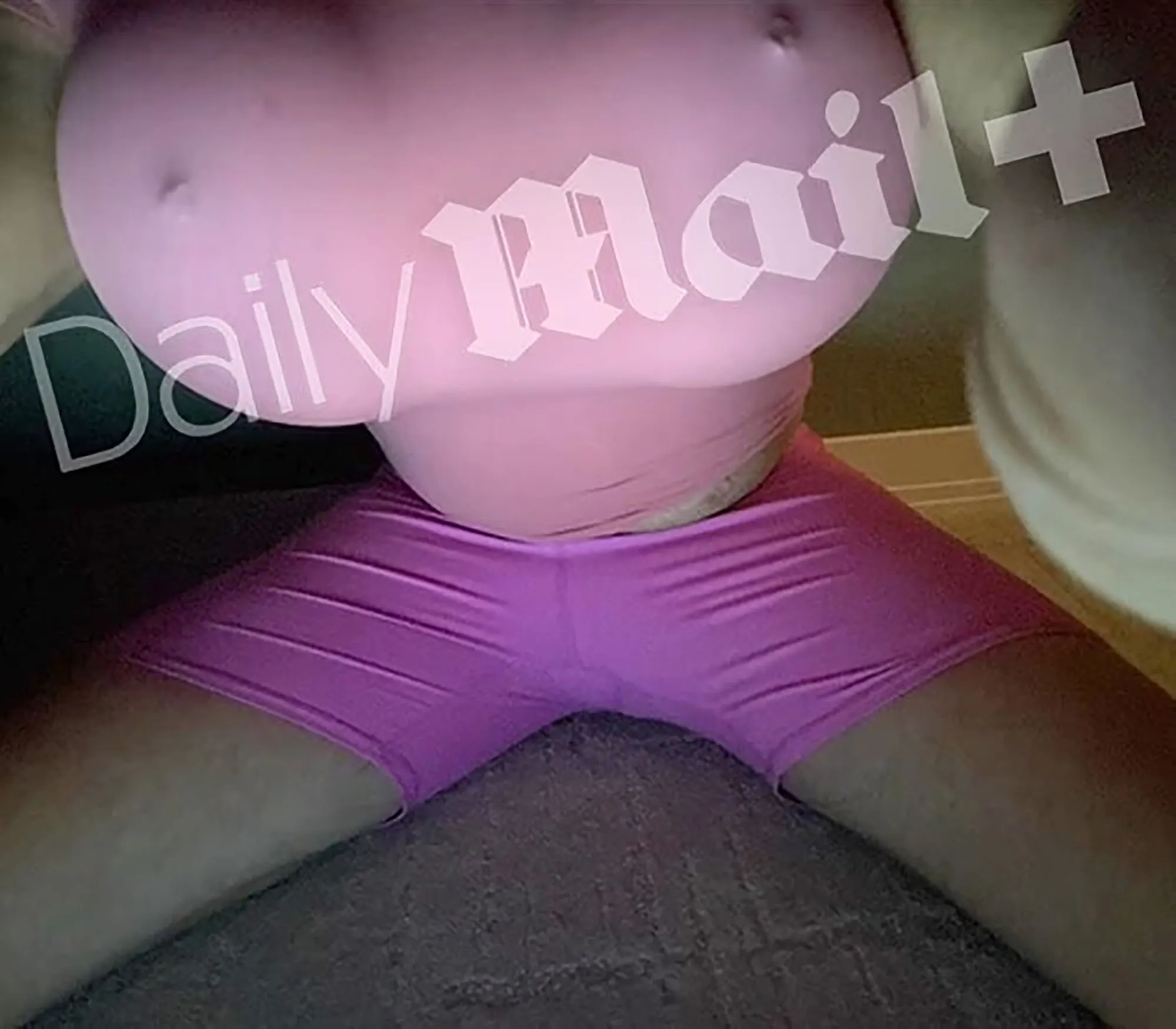 Bryon Noem wearing pink fake breasts and magenta shorts.