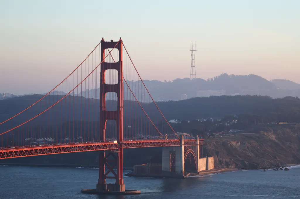 General view of the Golden Gate Bridge and the hilly San Francisco skyline.