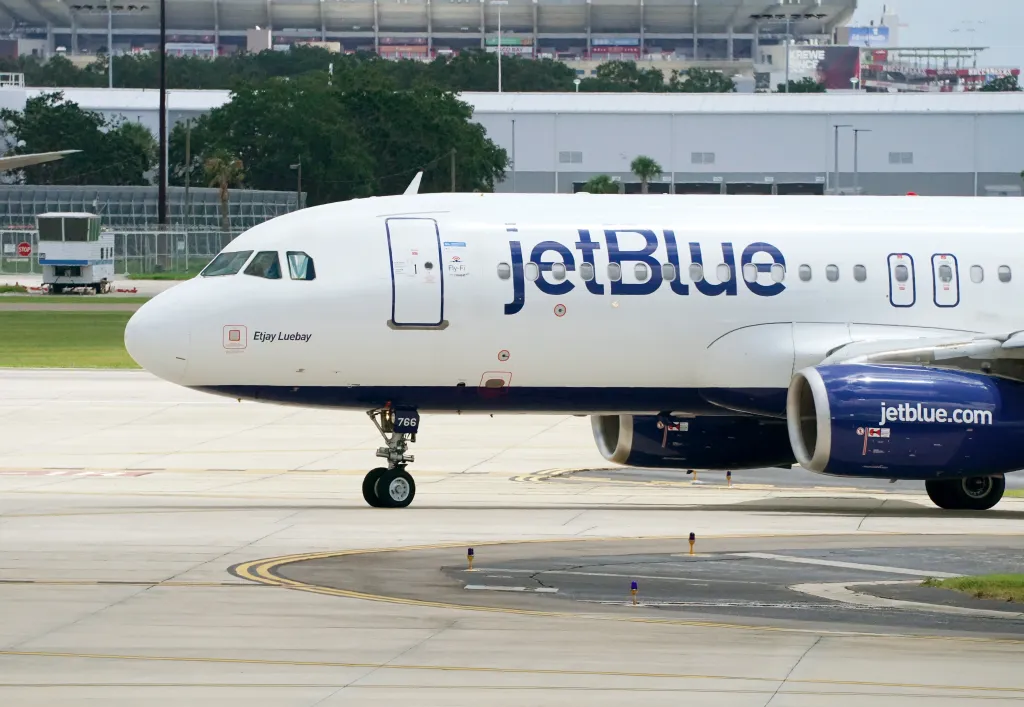 A JetBlue airplane on a tarmac at Tampa International Airport.