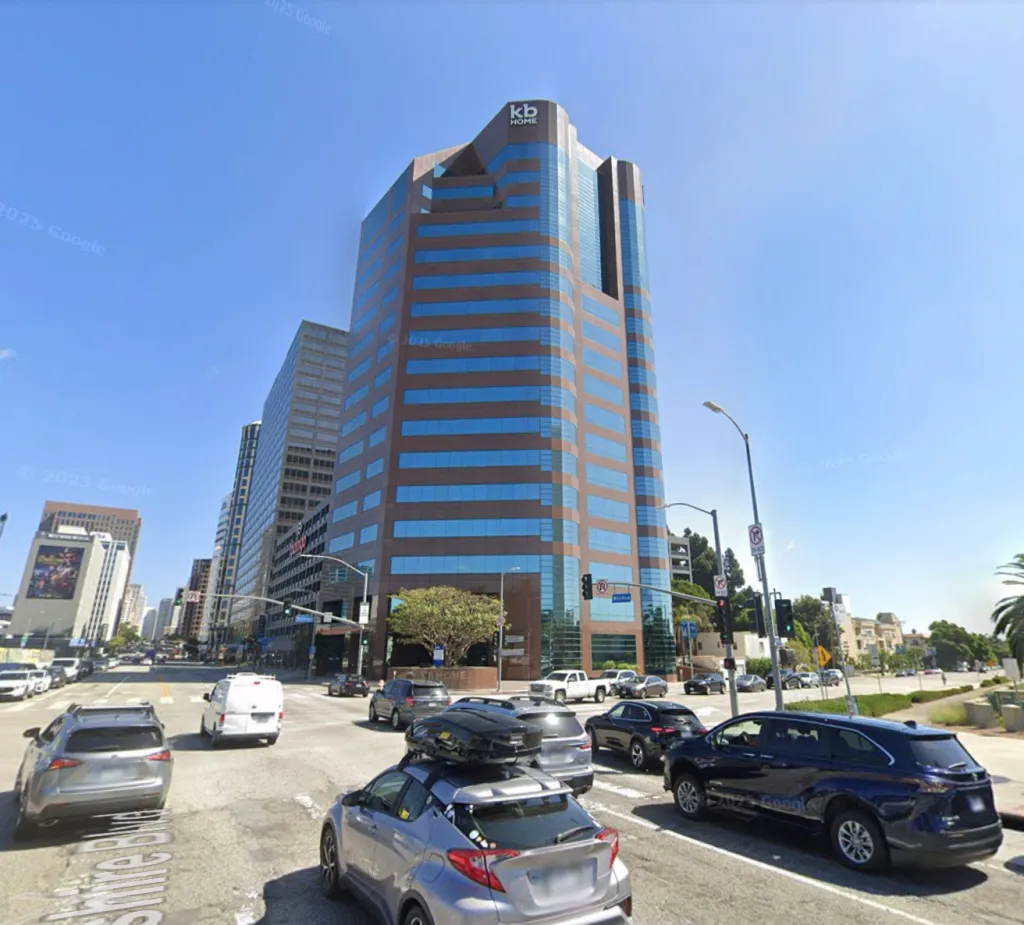 The KB Home office building in Los Angeles with cars on the street in the foreground.