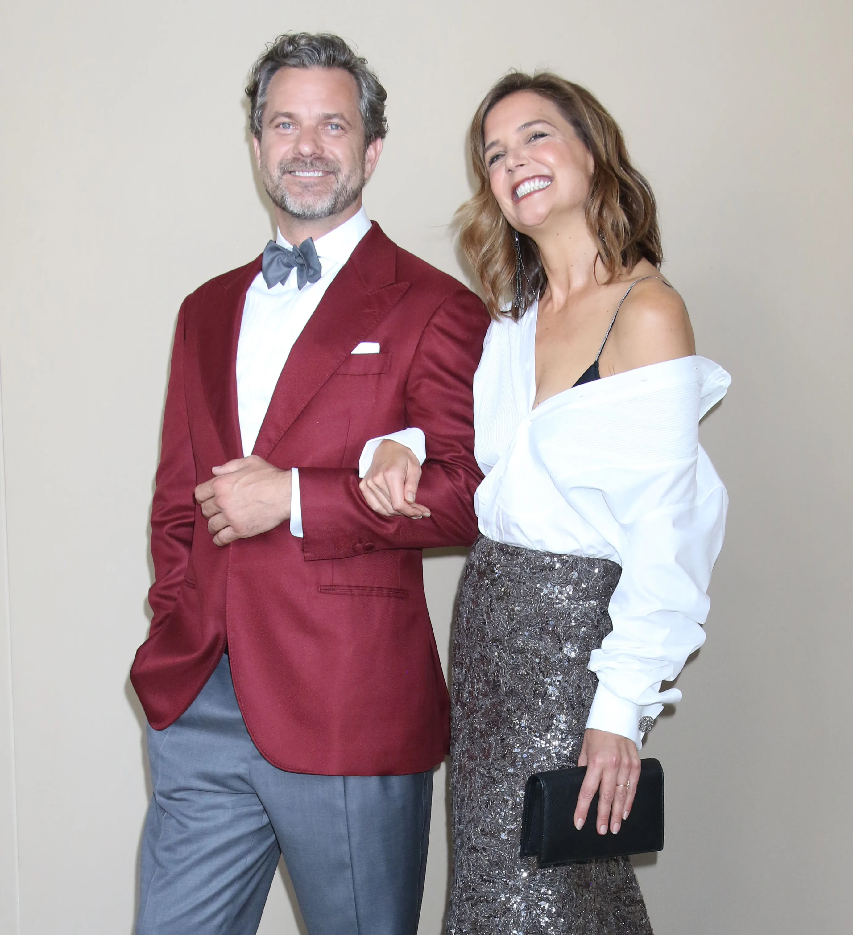 Joshua Jackson and Katie Holmes smiling while arm-in-arm at a New York City event.