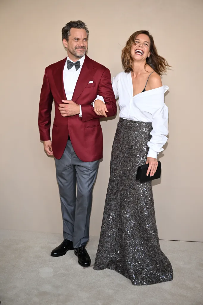 Joshua Jackson and Katie Holmes smiling at a gala screening.