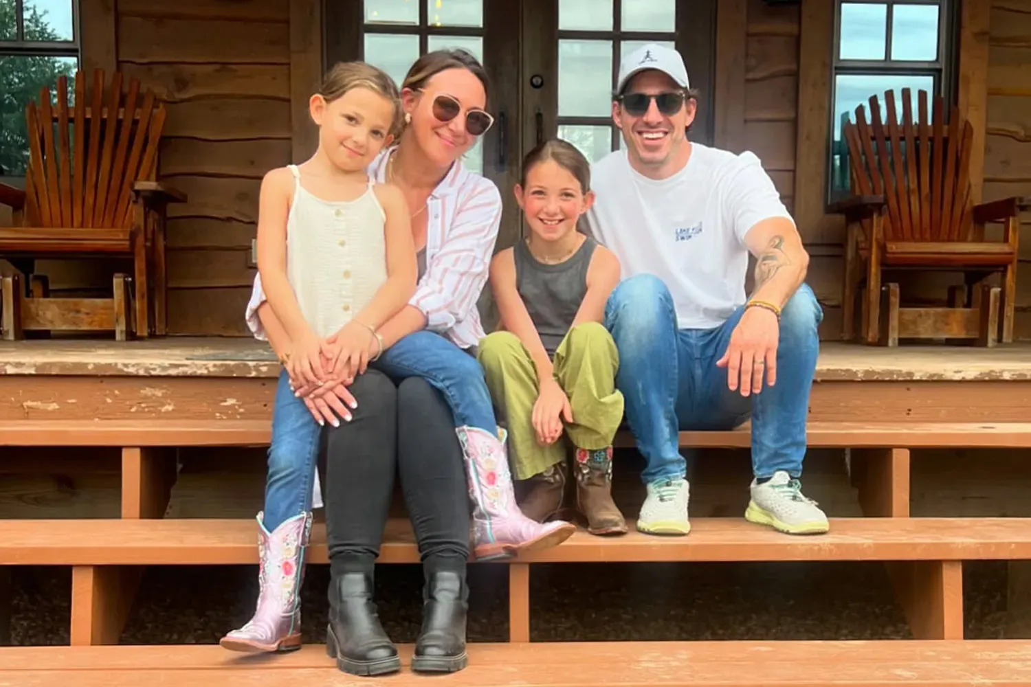 Haylie Duff and Matt Rosenberg with their two daughters sitting on steps.